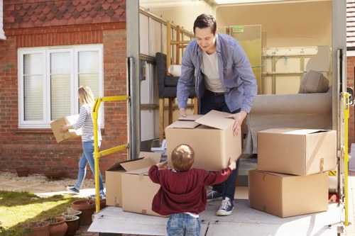 Piano movers protecting flooring and doorways in a residential property