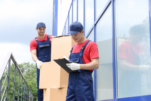 Removal van staff sorting reusable items and recyclable materials in Hounslow